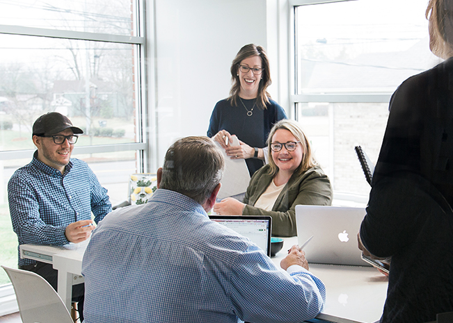 Thrive Creative Group Social Media Team Working In Conference Room